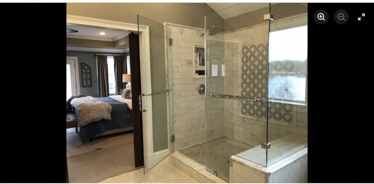 Primary bathroom remodel with frameless glass shower and lake view