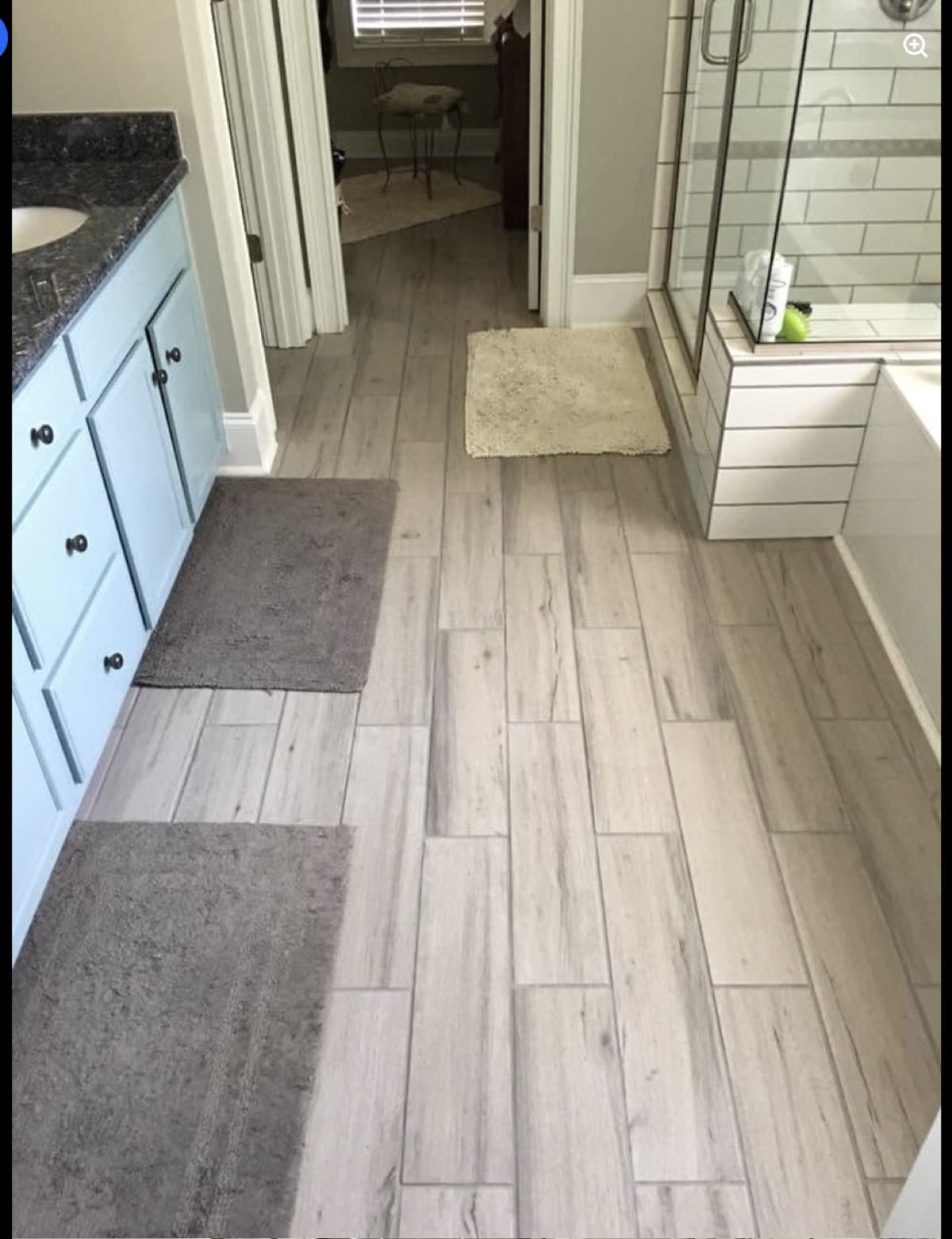 Bathroom remodel with wood-look tile flooring and glass shower