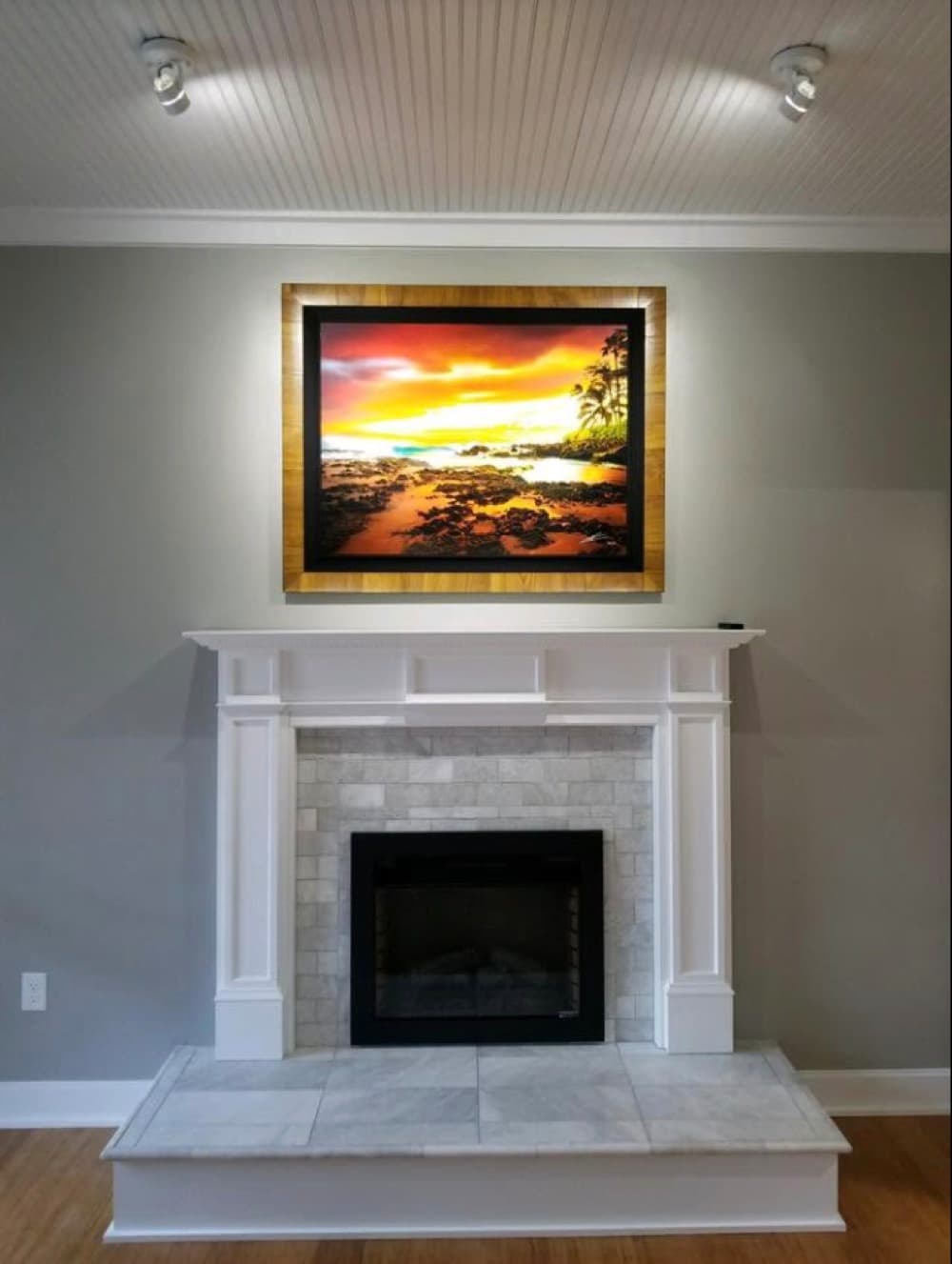 Custom fireplace remodel with tile surround and wood mantel