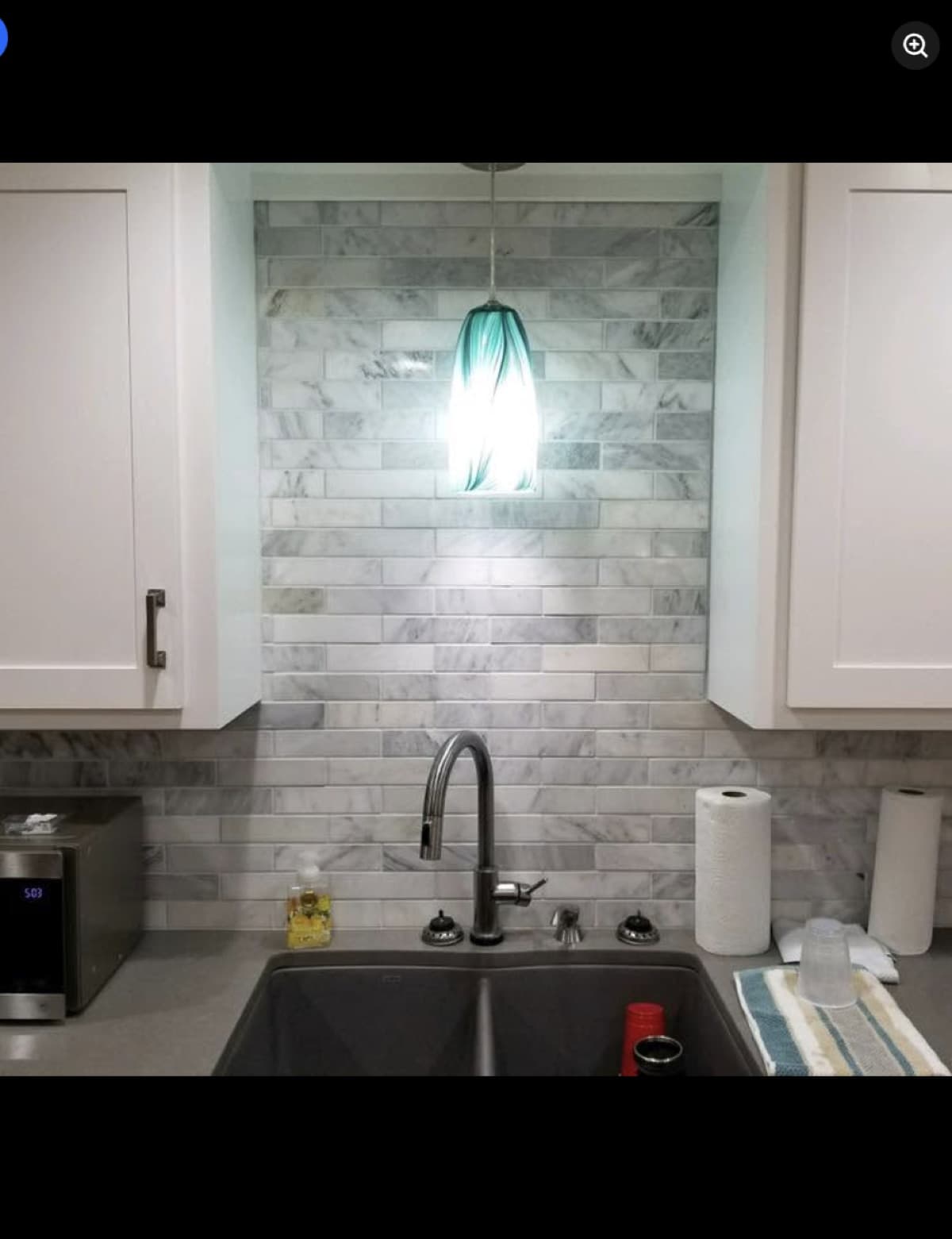 Kitchen remodel with marble subway tile backsplash and pendant lighting
