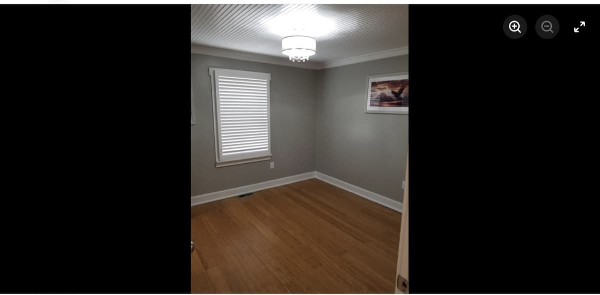 Room renovation with new hardwood flooring and paint