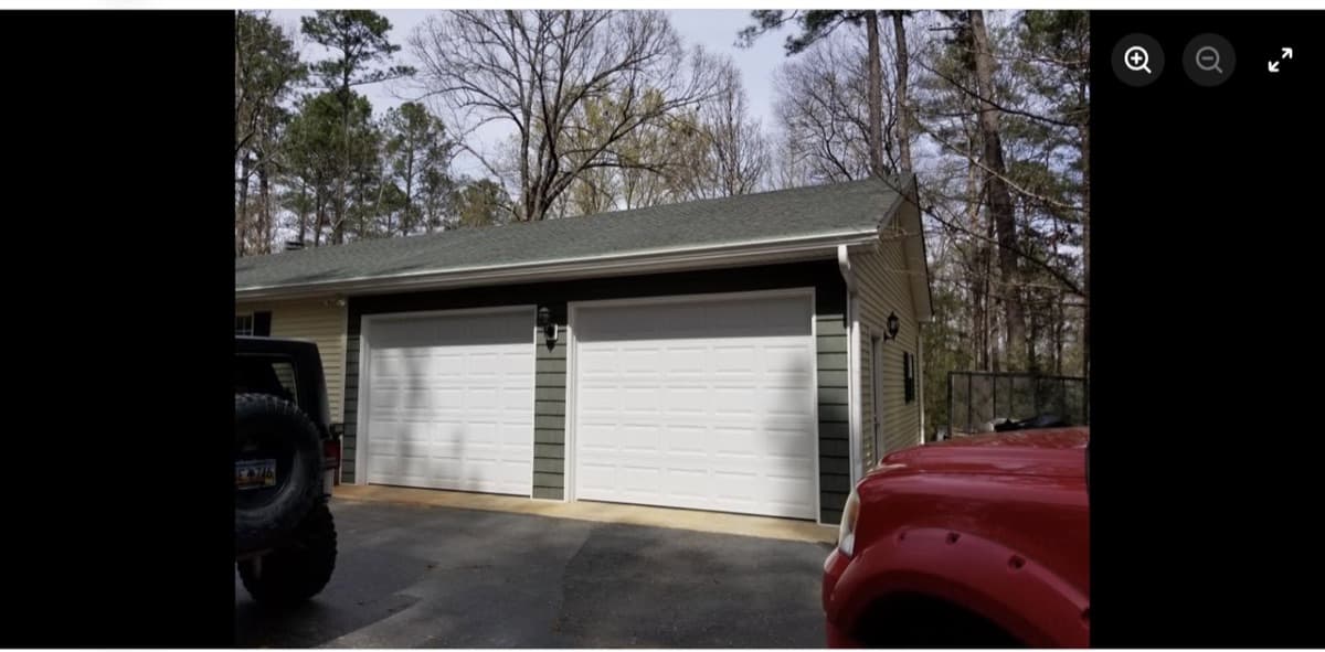 Completed two-car detached garage with siding and shingle roof