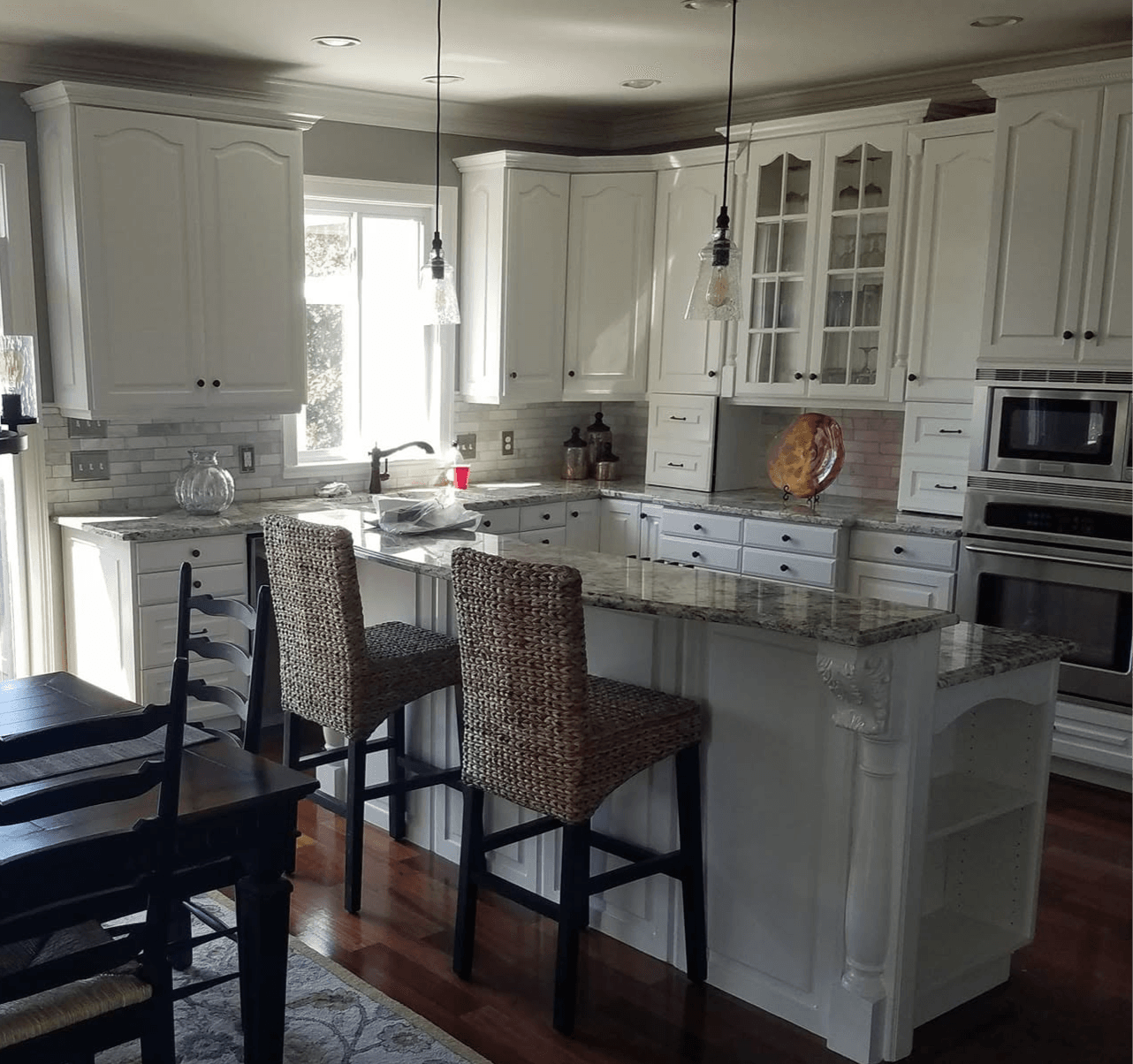 Clean renovated ktchen with marble countertops and white paint