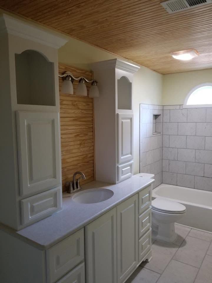 Bathroom remodel all white with wood above the sink