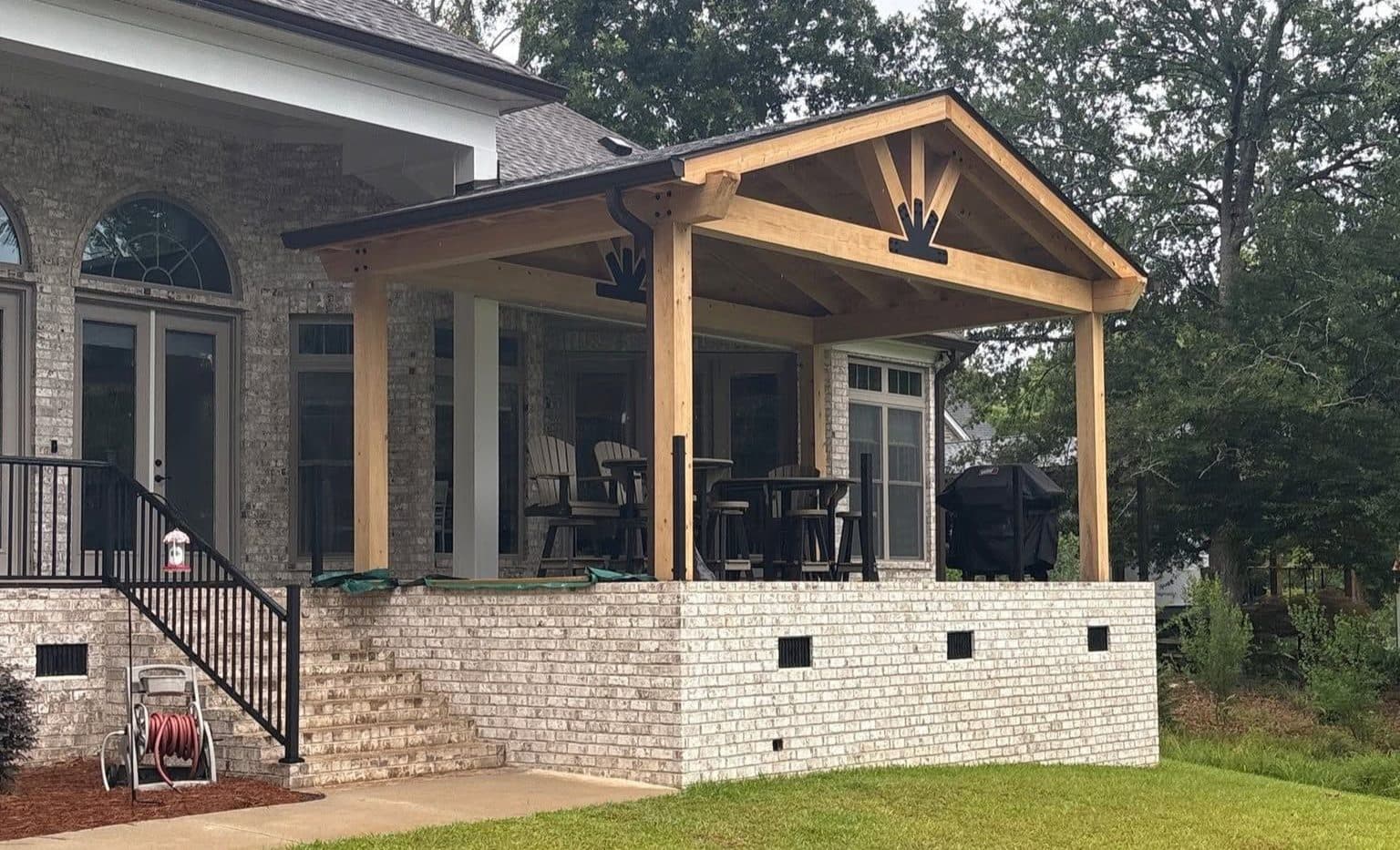 Outdoor Lounge with wood overhang and black roofing