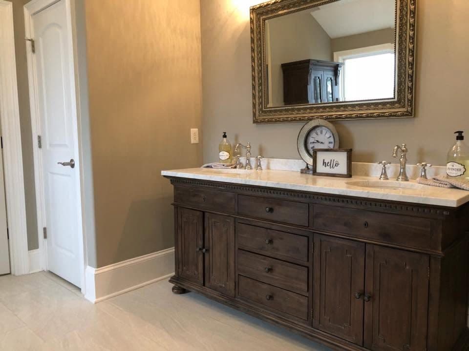 Bathroom remodel with white countertop and wood drawers