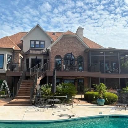 Wood deck with screened patio on a two-story house
