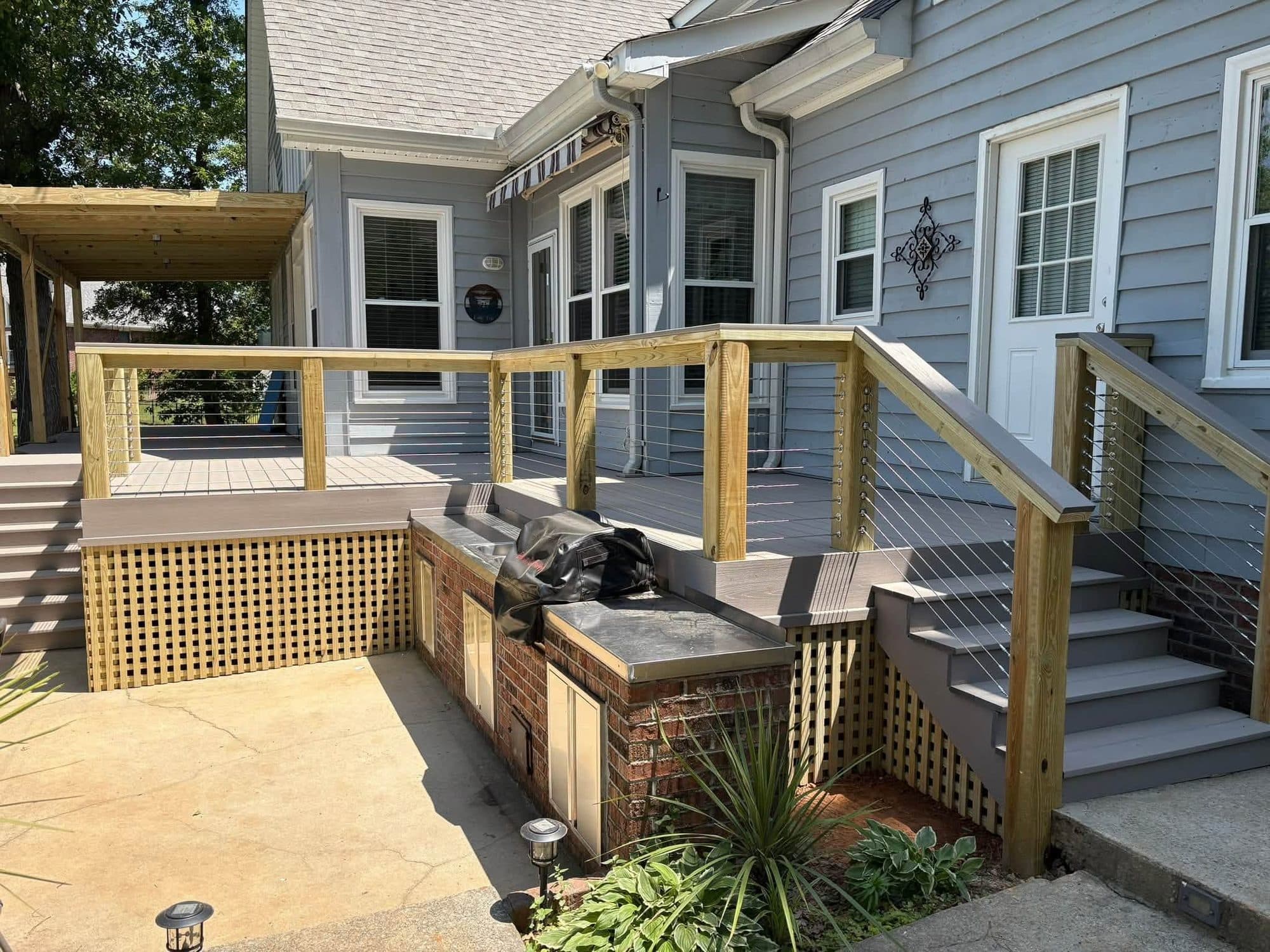 Wood cable railing with new outdoor brick kitchen
