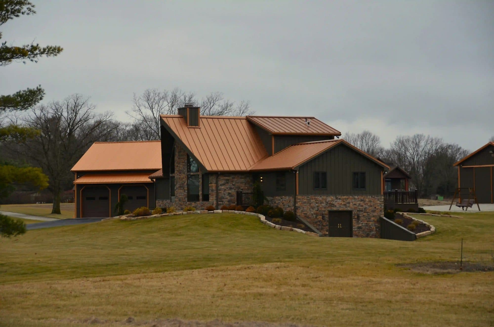 Complete beautiful orange metal roofing on dark house